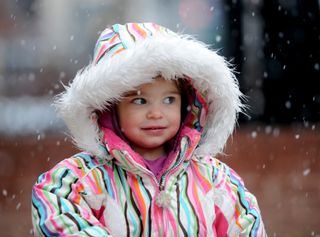 Mila Makovec, 2, came out to experience the snow with her parents on the Pearl Street Mall.