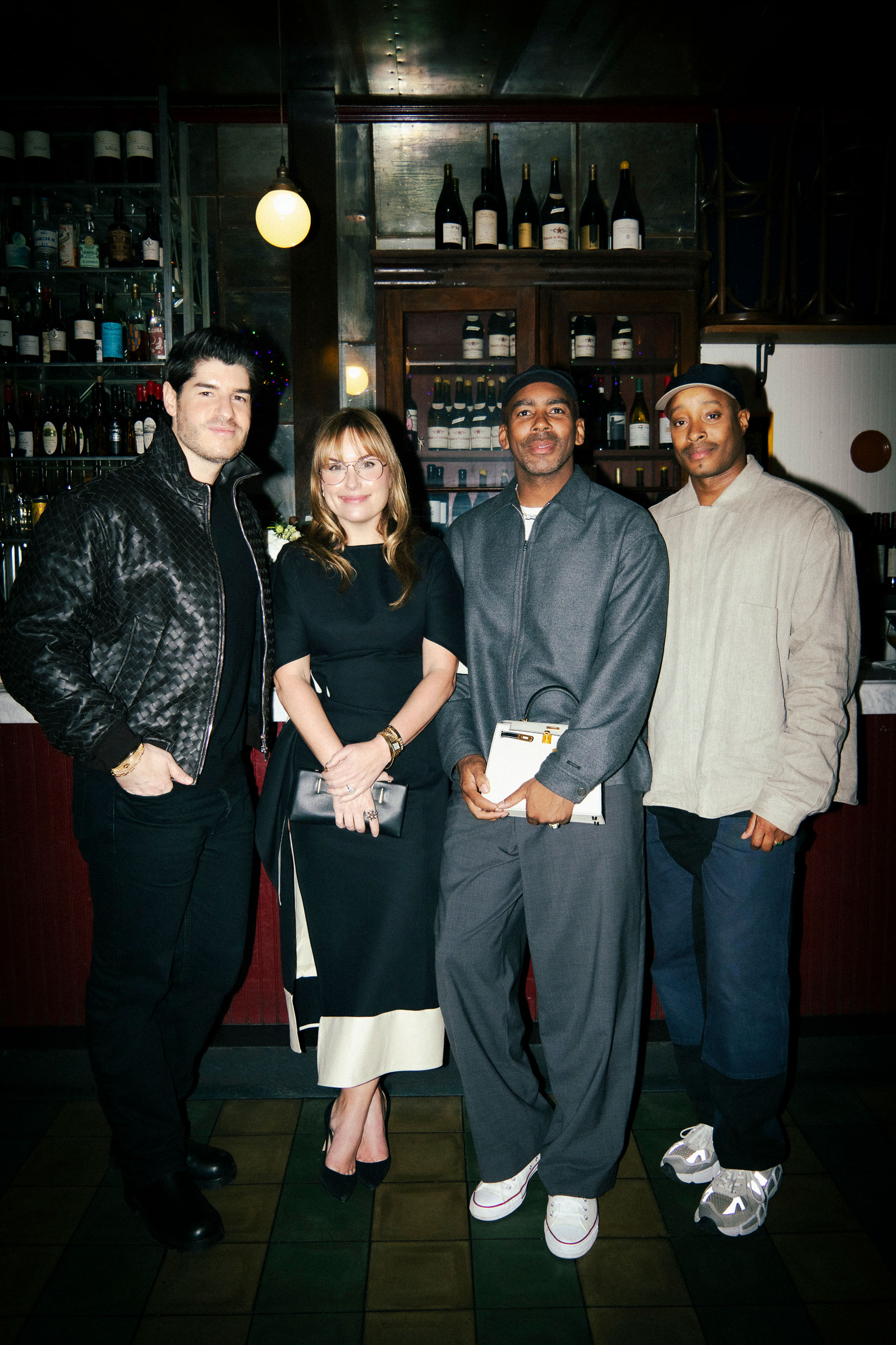 a group of four people pose at a dinner party