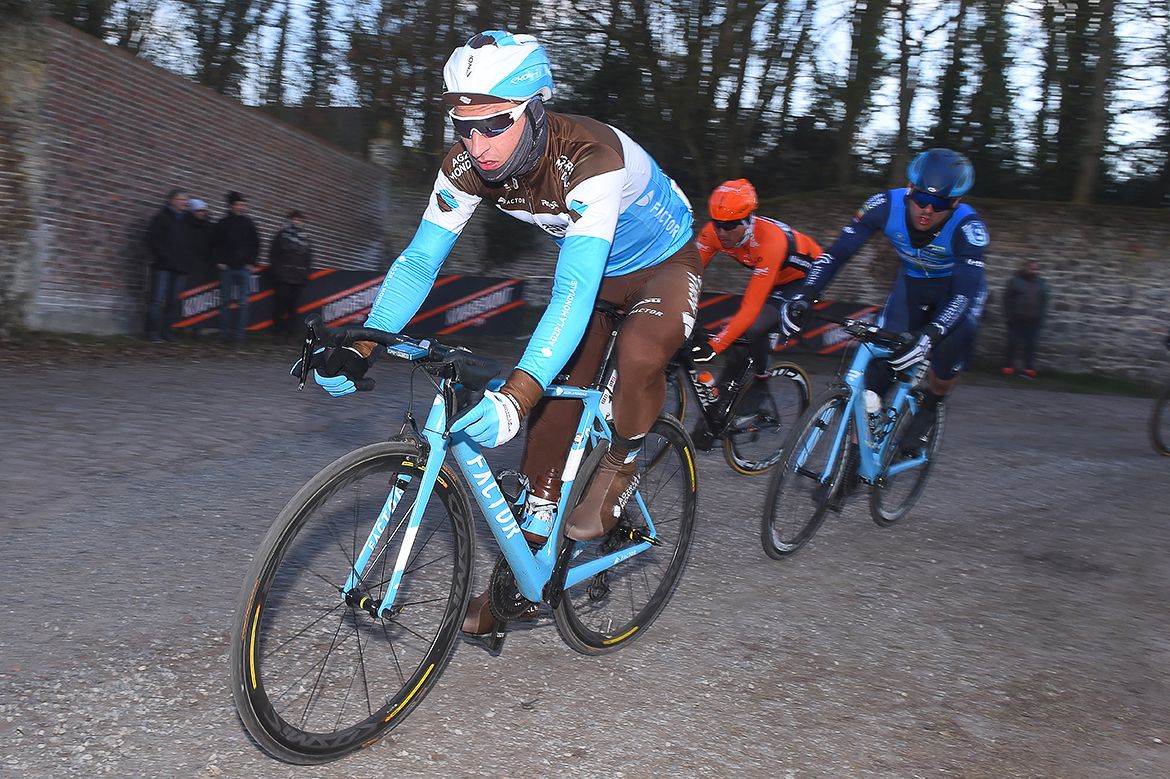 An AG2R rider is bundles up against the cold