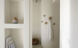 Towel hooks create a soft contract in the room