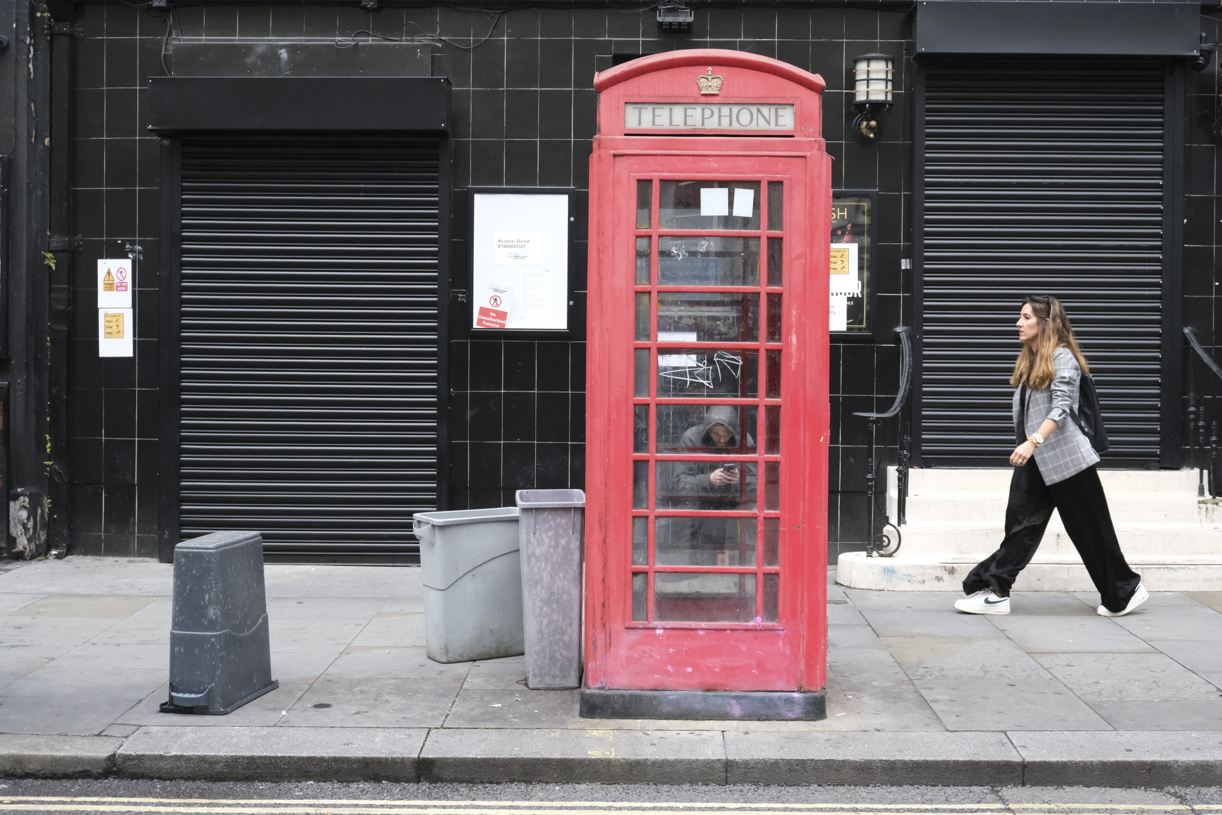 London street photo of a red telephone box and black shop front, taken with the Fujifilm X-M5