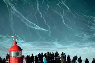 A surfer rides a huge wave off the coast of Nazare, Portugal.