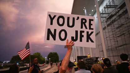 Protesters gather to watch President Donald Trump's name removed from Kennedy Center