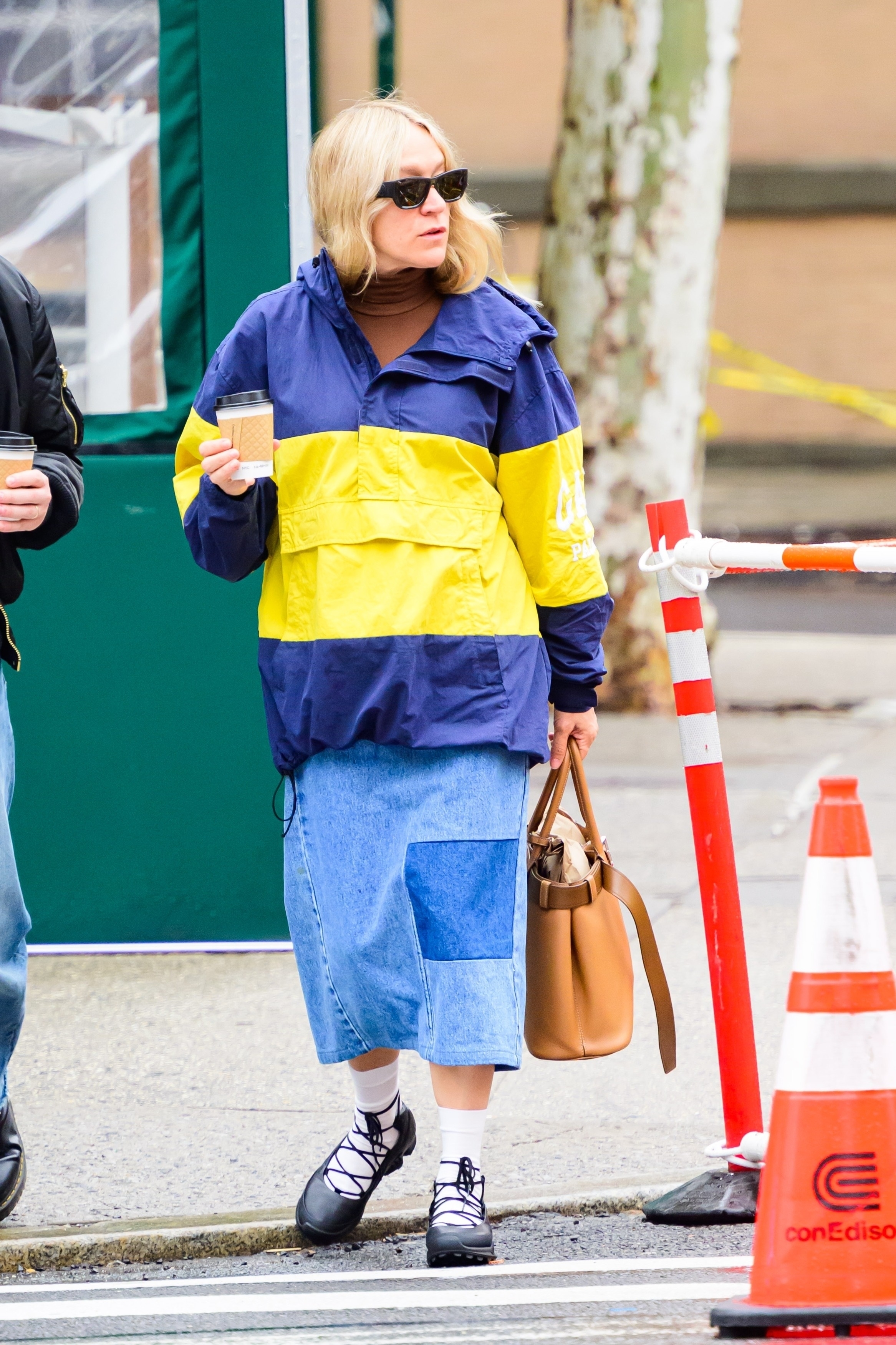 Chloë Sevigny approved the belt bag trend with a tan two-tone version from Prada, an oversized windbreaker, and a denim skirt.