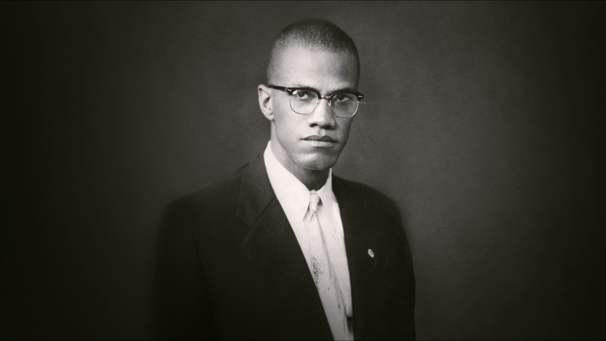 Black and white photo of Malcolm X from Blood Brothers: Malcolm X and Muhammad Ali