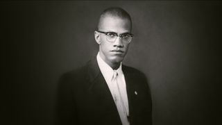 Black and white photo of Malcolm X from Blood Brothers: Malcolm X and Muhammad Ali