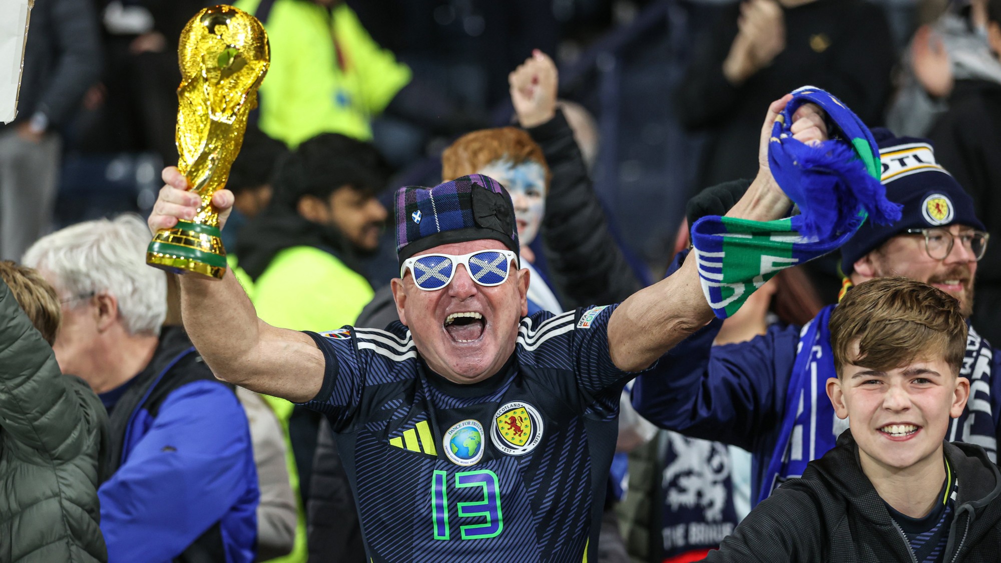 A Scotland fan holds a fake World Cup trophy during a 2026 FIFA World Cup Qualifying match against Greece
