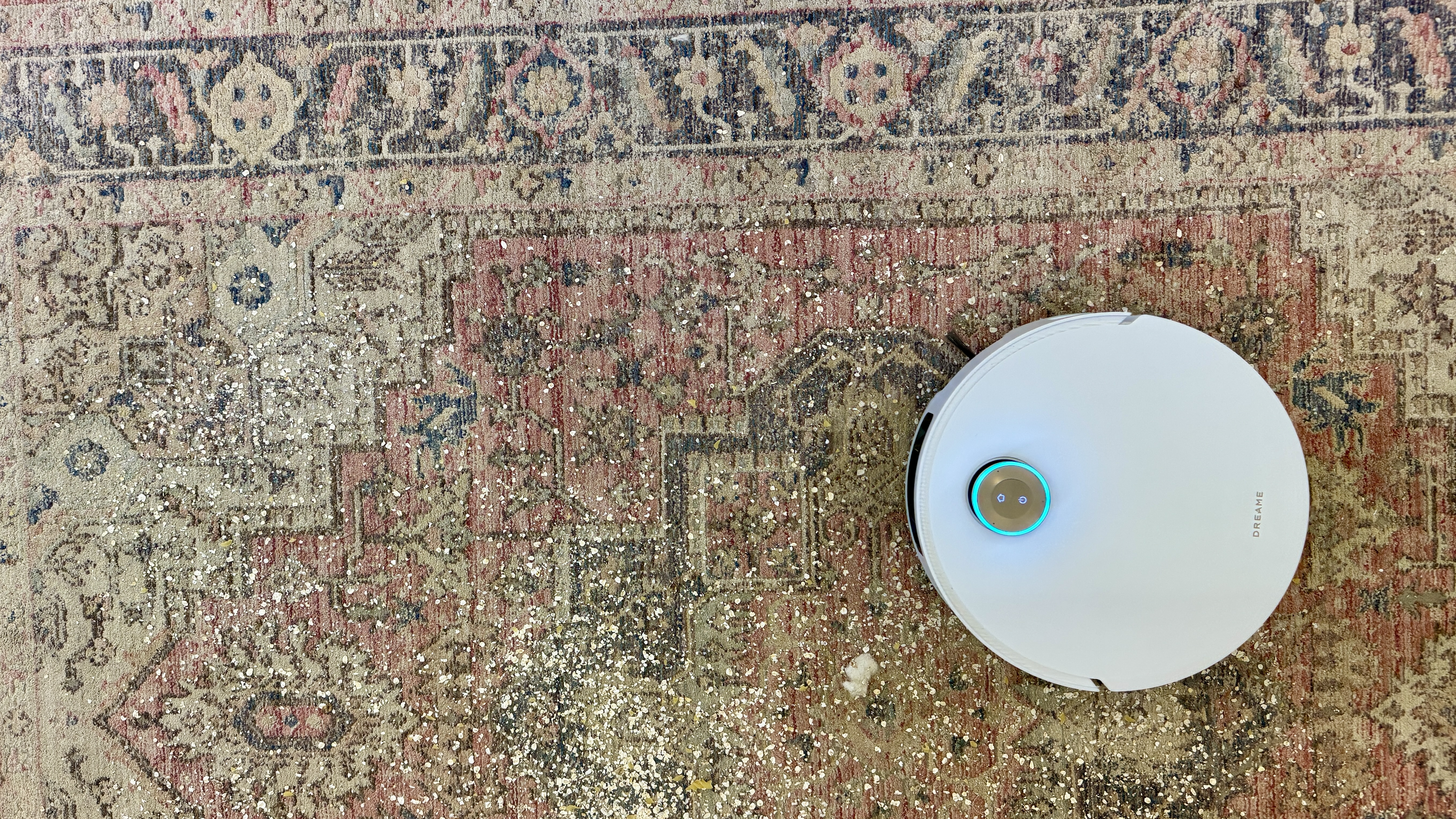 Dreame Matrix10 Ultra robot vacuum cleaning debris from a large rug