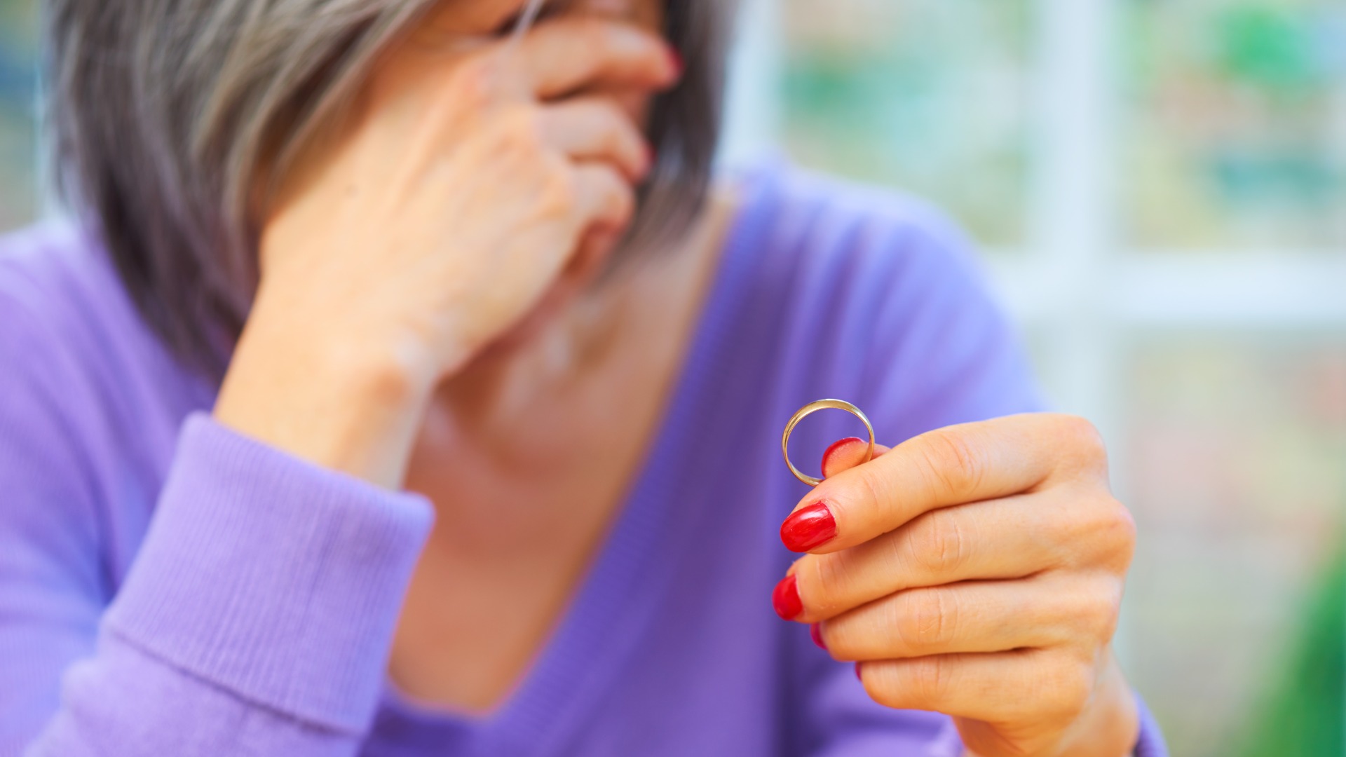 Woman taking off her wedding ring