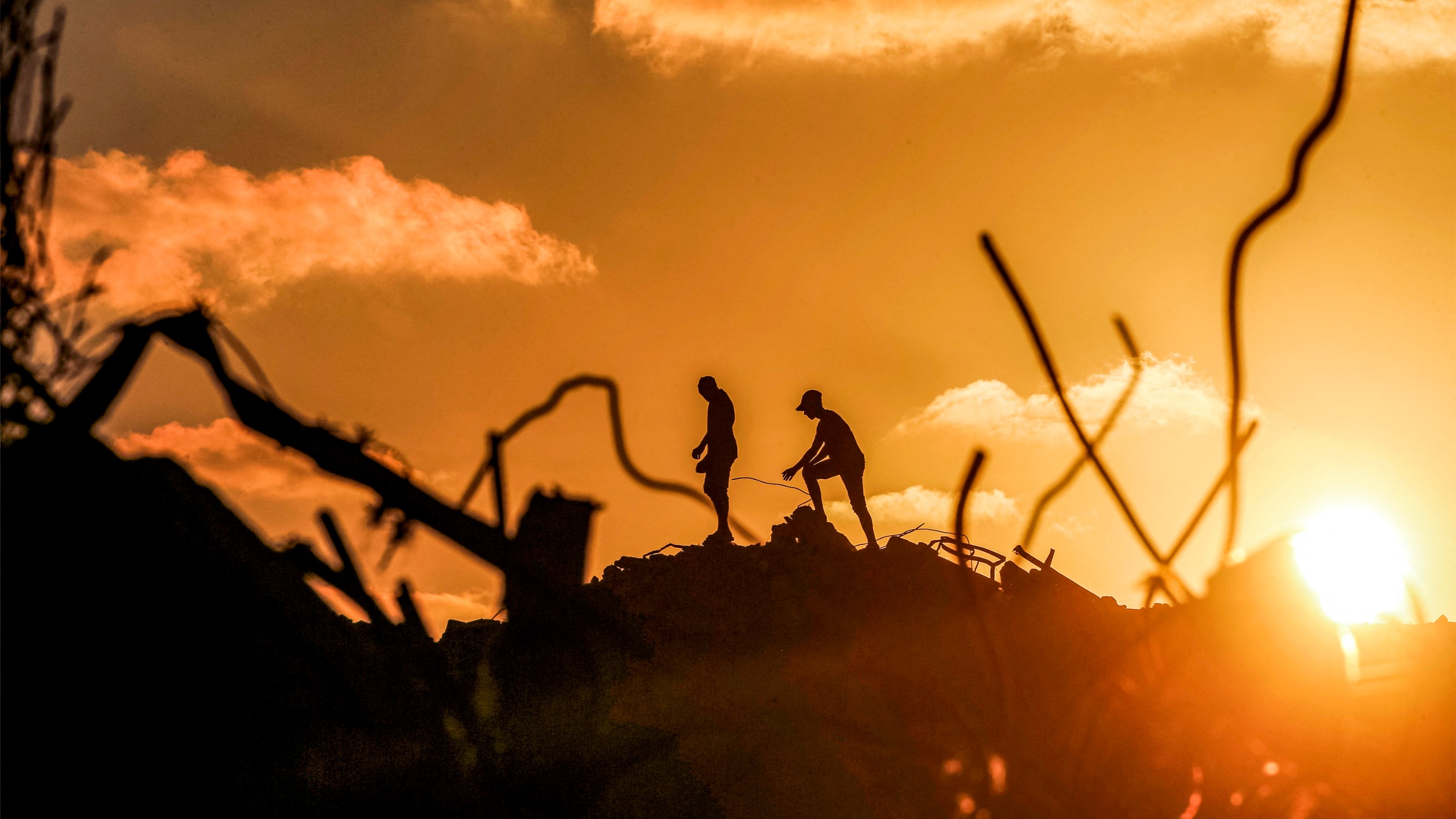 Men walk through rubble at the Bureij camp for Palestinian refugees in the central Gaza Strip on September 14, 2026