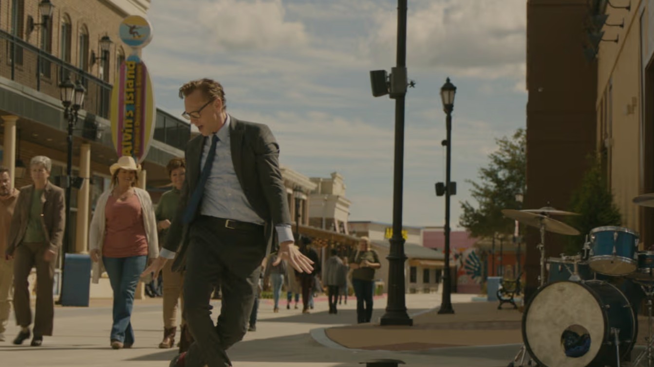 Tom Hiddleston dances in the street in The Life of Chuck