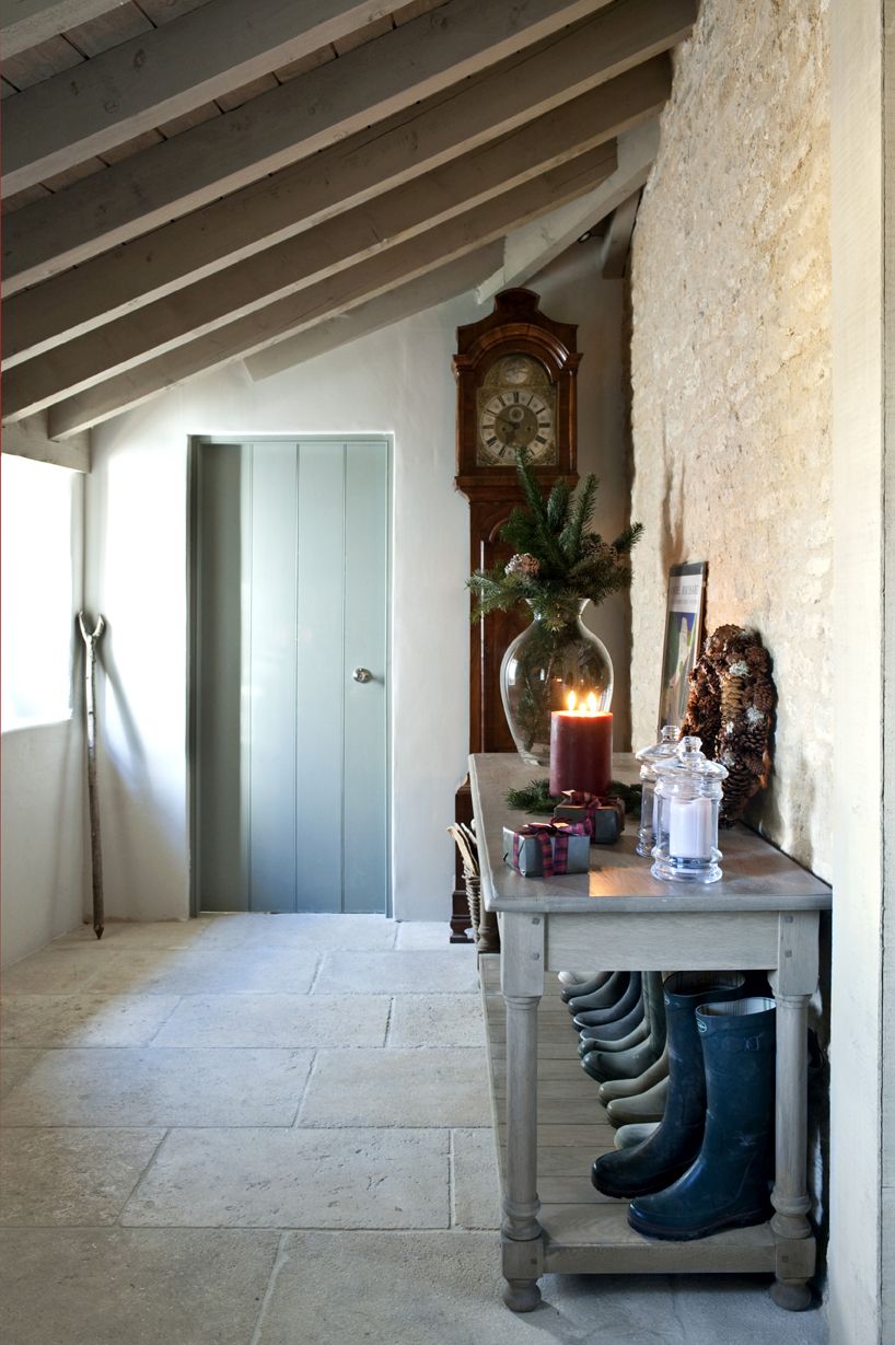 Stone hallway, blue wooden door, grey bootshelf