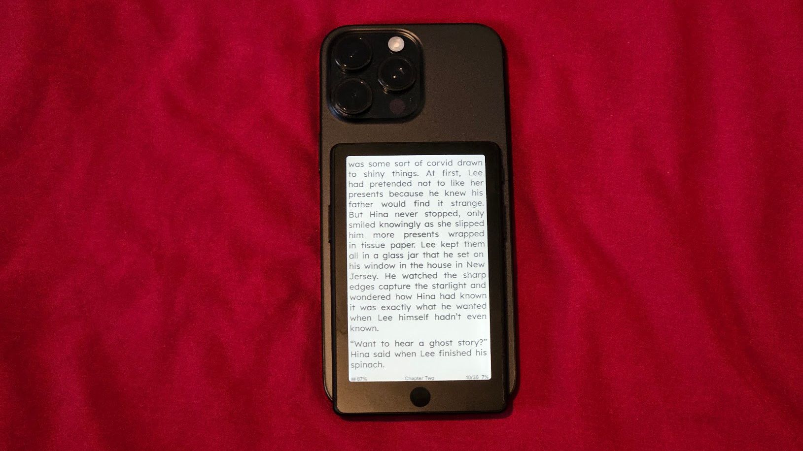 The Xteink X4 Pro attached to an iPhone 16 Pro Max