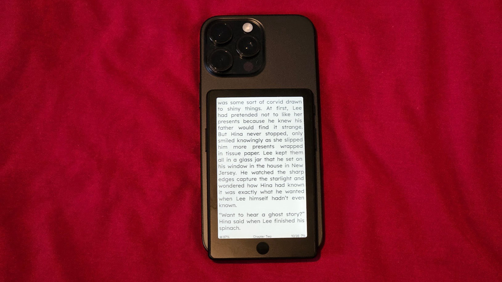 The Xteink X4 Pro attached to an iPhone 16 Pro Max