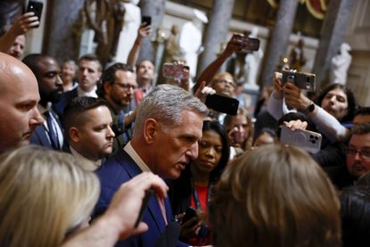 Kevin McCarthy speaks with a crowd of reporters