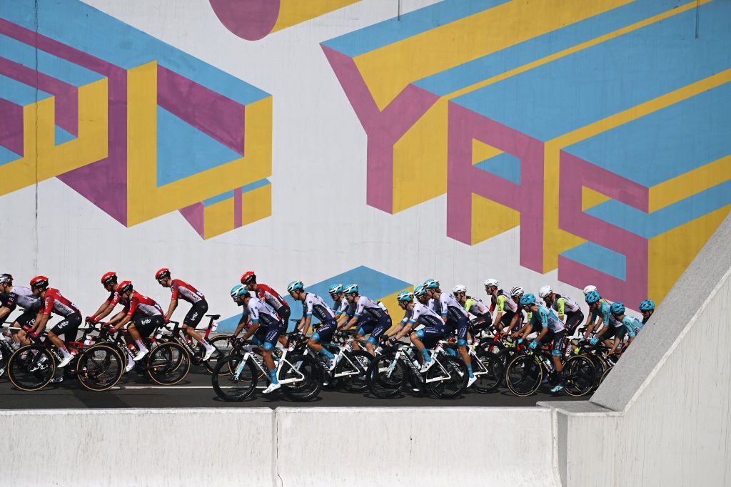 ABU DHABI UNITED ARAB EMIRATES FEBRUARY 22 A general view of the peloton passing in front of a graffiti decorating a wall during the 7th UAE Tour 2025 Stage 6 a 165km stage from Abu Dhabi Cycling Club to Abu Dhabi Breakwater UCIWWT on February 22 2025 in Abu Dhabi United Arab Emirates Photo by Dario BelingheriGetty Images