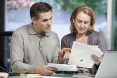 A fiftysomething couple goes over finances.