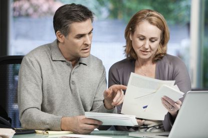 A fiftysomething couple goes over finances.