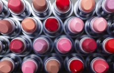 A view of many different colour lipsticks from above.