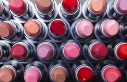 A view of many different colour lipsticks from above.