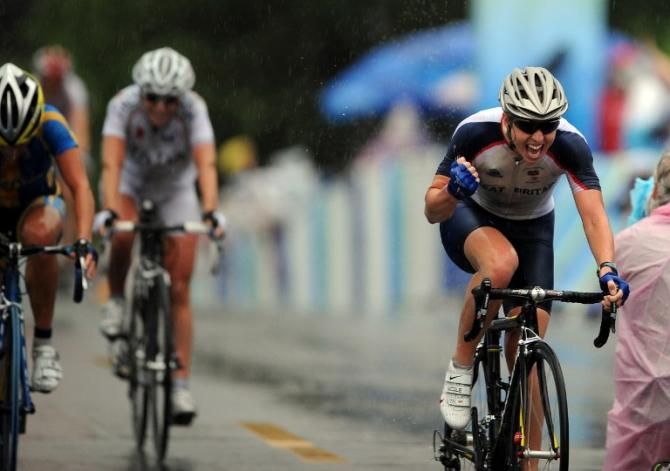 Great Britain's Nicole Cooke celebrates her victory in the 2008 Olympic Games road race ahead of Emma Johansson (Sweden) and Tatiana Guderzo (Italy)