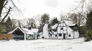 snowy exterior of extended cottage