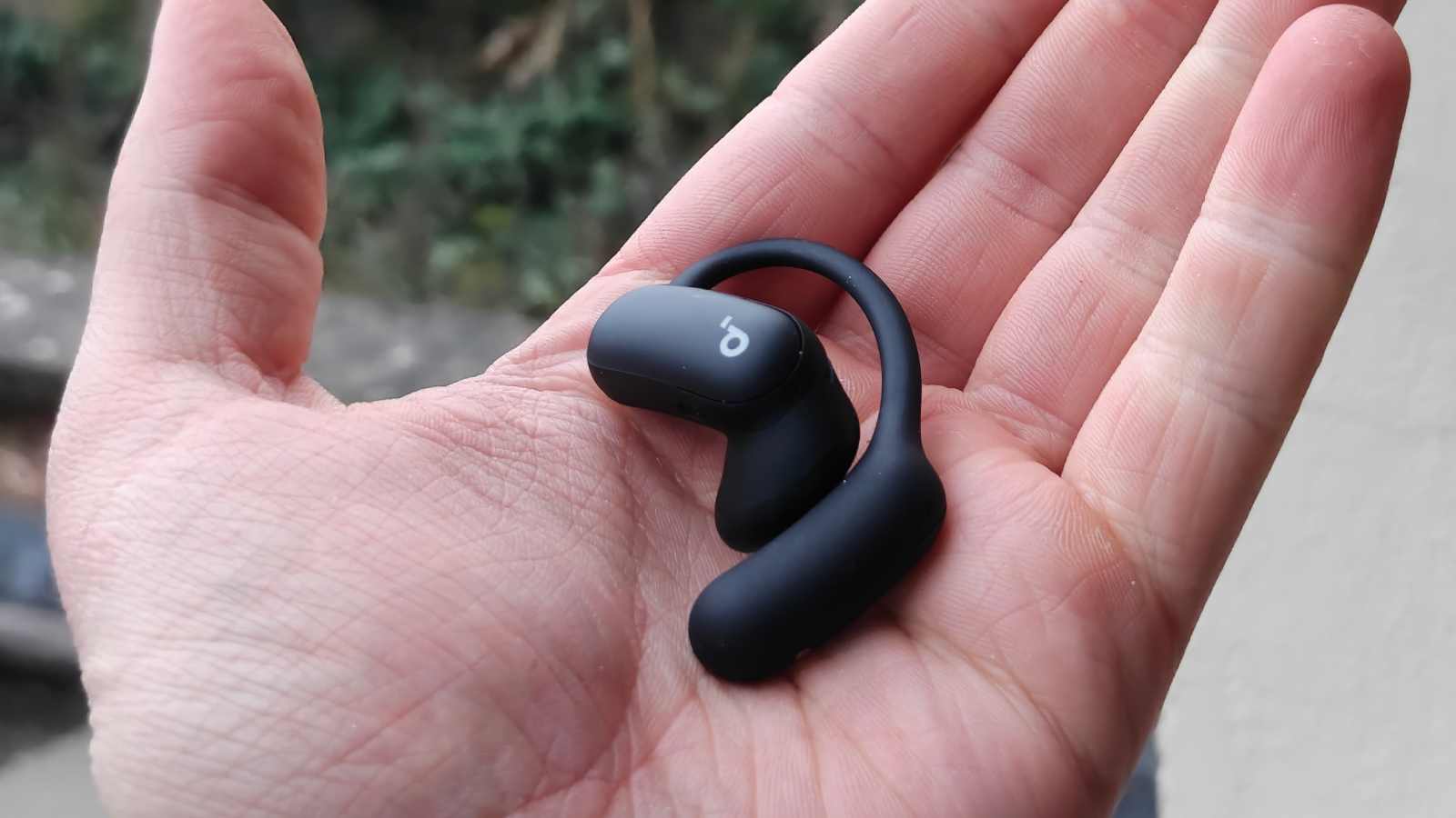 The Soundcore Aerofit 2 Pro in a man's hand.