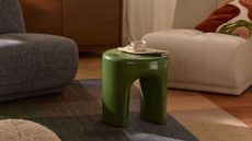 a glossy green table in a living room