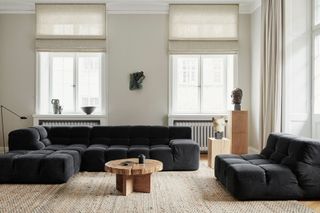 a dark gray corduroy sofa in a living room