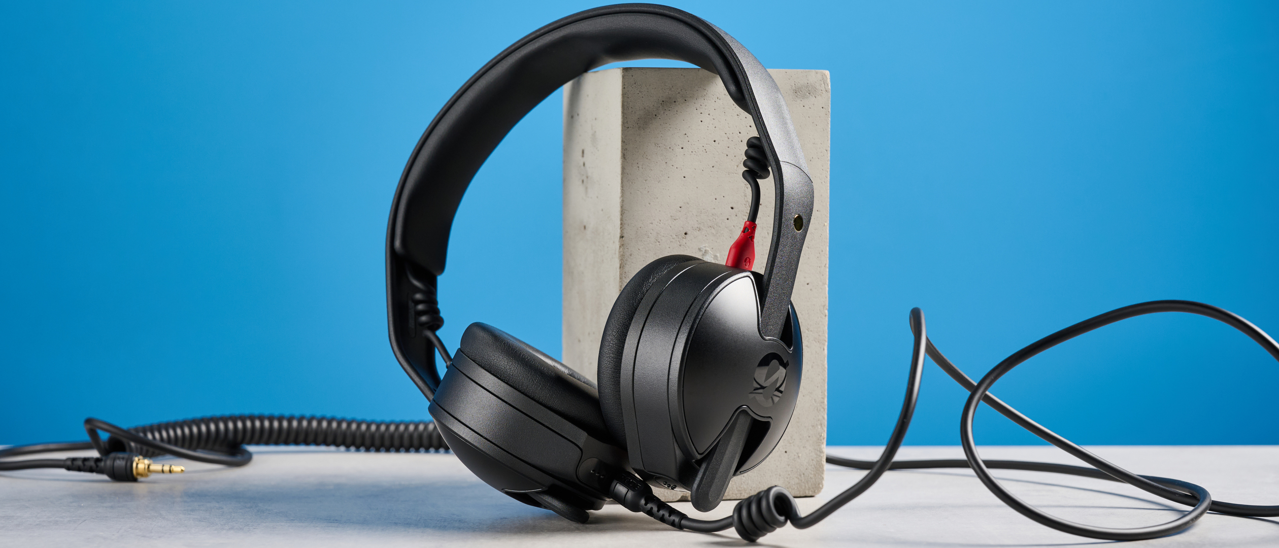 the rode nth-50 studio headphones in black showing the long cable, 3.5mm jack, 1/4 jack, and in use