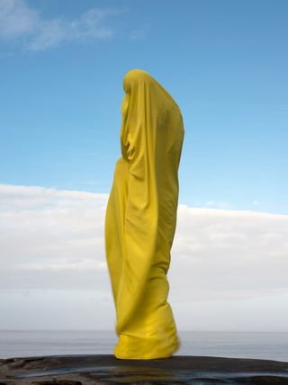 A person wrapped in yellow fabric.