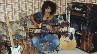 Slash poses for a portrait in his bedroom with his guitars and a Marshall halfstack amplifier in 1983 in Los Angeles, California.