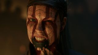 A close-up of Senua baring her teeth