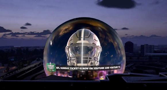 The Las Vegas Sphere is lit up with NFL helmets to promote YouTube's Sunday Ticket.