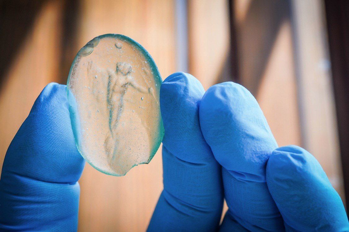 A glass engraving of a human figure