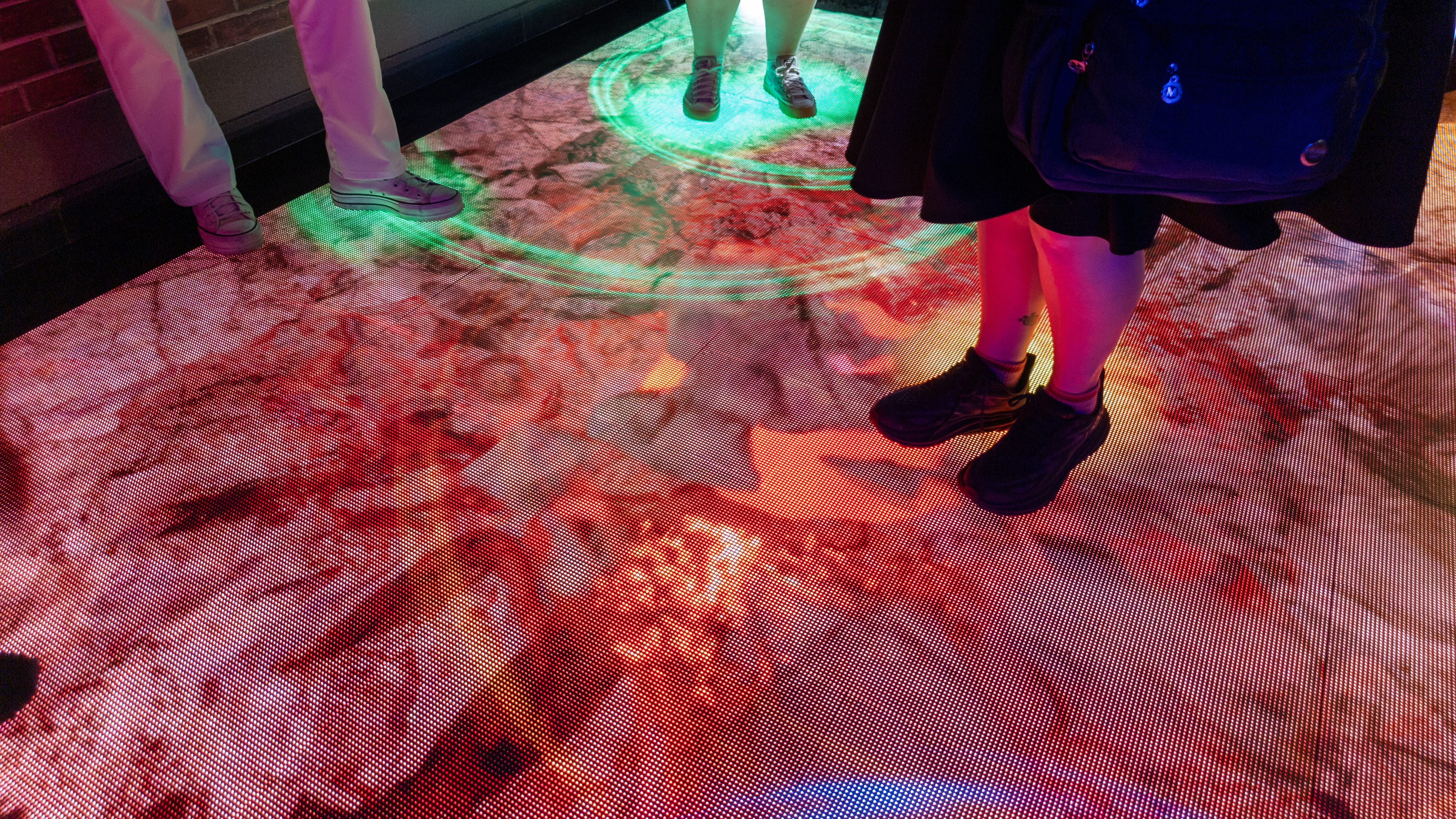 A digital floor display showing a crumbling floor at Google's San Diego Comic-Con Rewards Lab