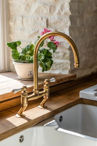 British Standard by Plain English kitchen with swan-neck antique-style-brass tap and ceramic butler's sink