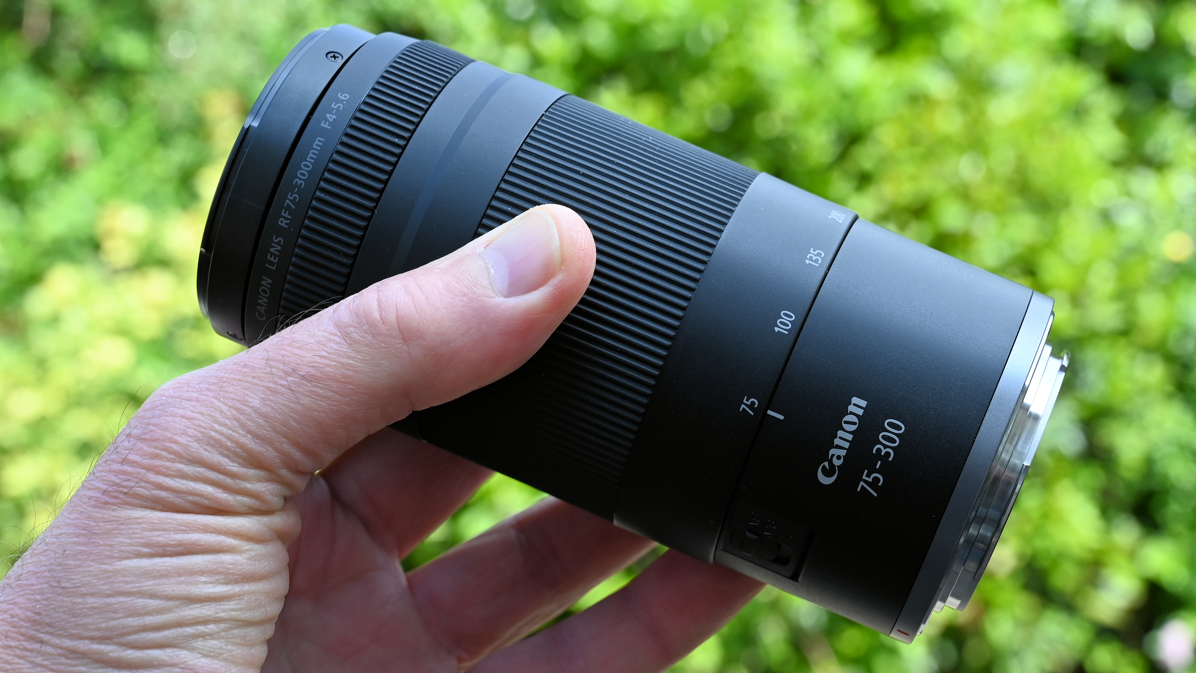 Canon RF 75-300mm f/4-5.6 product shot held in hand
