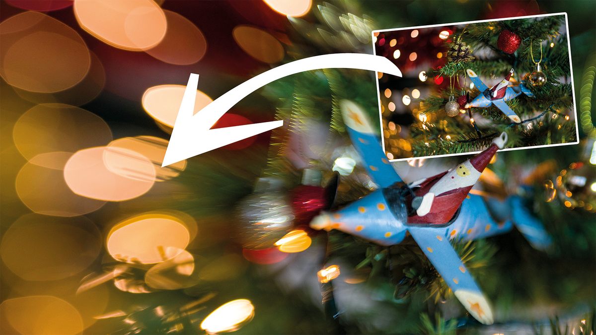 Image of Santa in a plane decoration on a Christmas tree with large discs of bokeh, captured with a Lensbaby Spark 2.0 