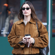 Hailey Bieber seen in SoHo on January 30, 2025 in New York City wearing a brown suede jacket and the row bag