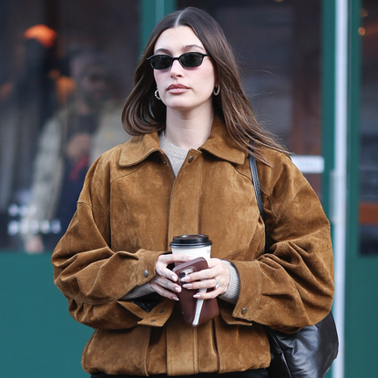 Hailey Bieber seen in SoHo on January 30, 2025 in New York City wearing a brown suede jacket and the row bag