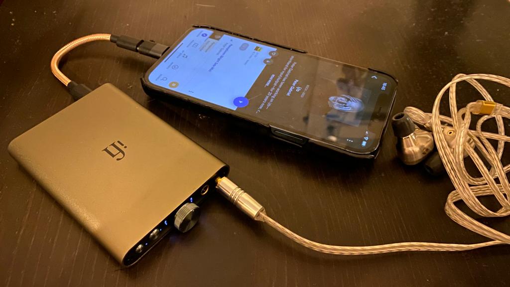 iFi hip-dac 3 on a table, next to a smartphone