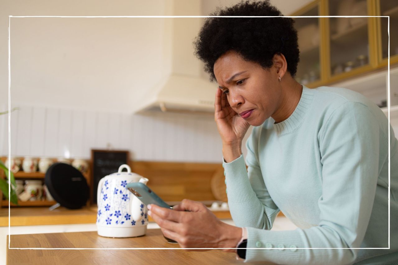 A worried woman looking at her phone