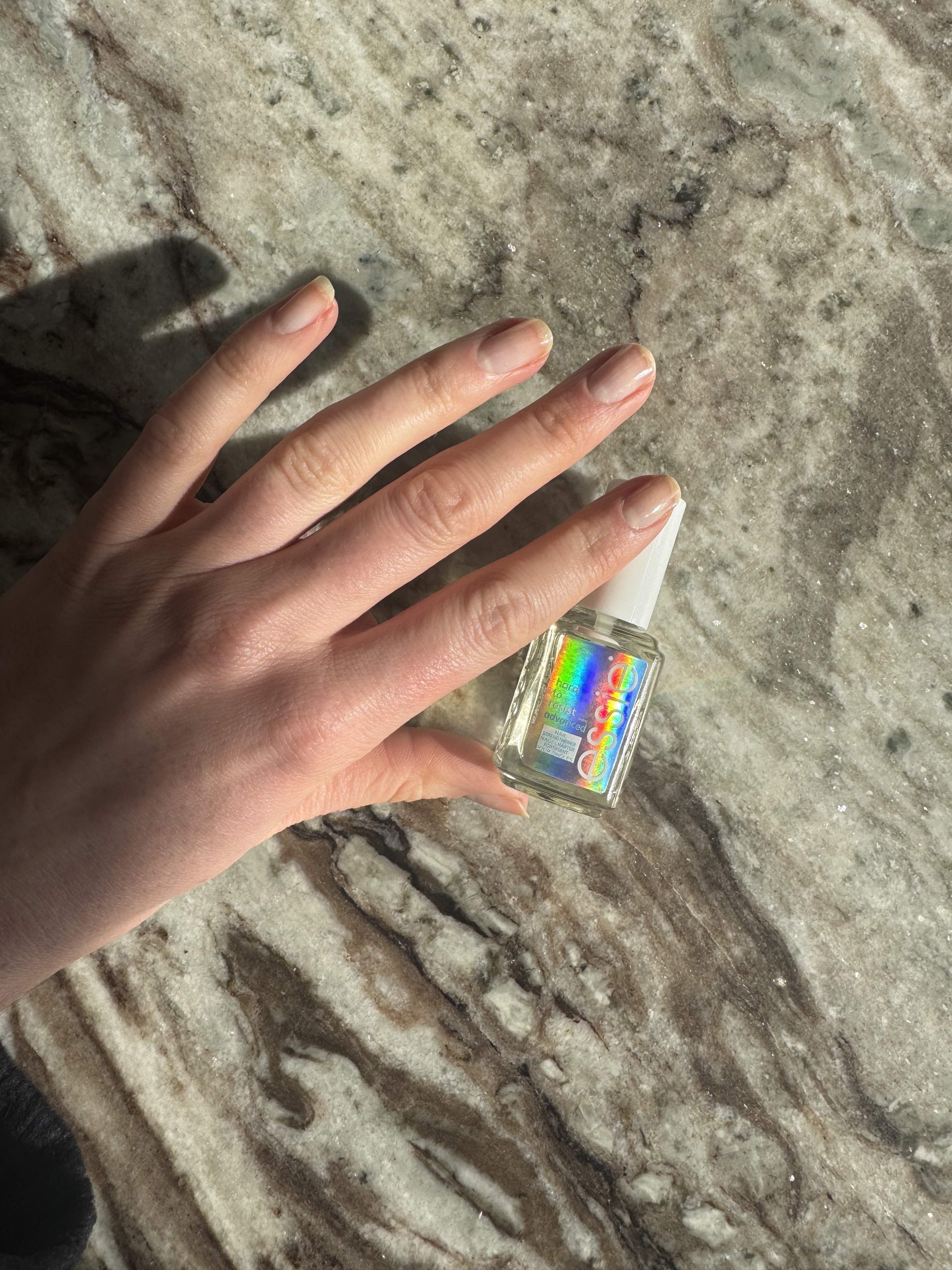 Eleanor's nails after applying the essie hard to resist nail strengthener in clear