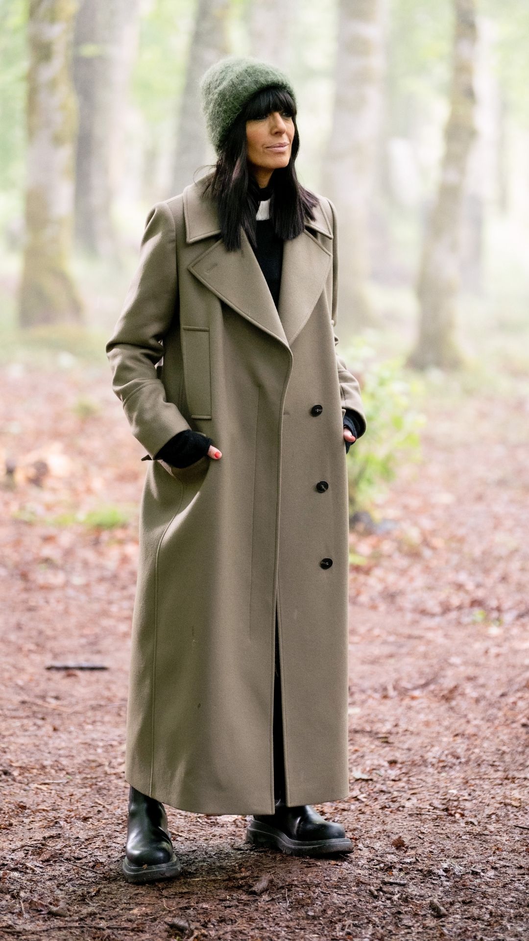Claudia Winkleman wearing a trench coat on The Traitors