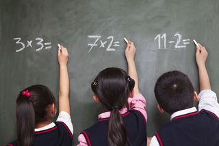 kids doing math at a chalkboard