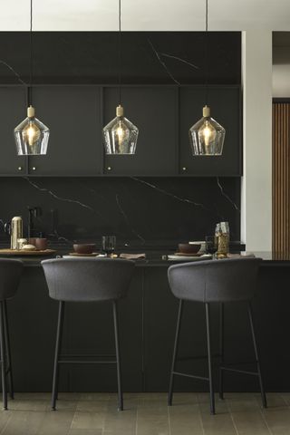 black kitchen with bar stools