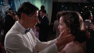 Crispin Glover holds Lea Thompson's face in his hands in Back To The Future.