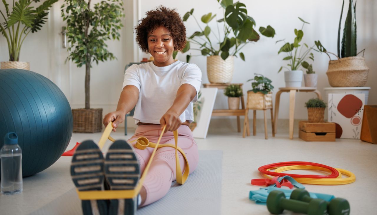 Woman performing seated row with resistance band