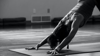 Woman doing downward-facing dog position during yoga